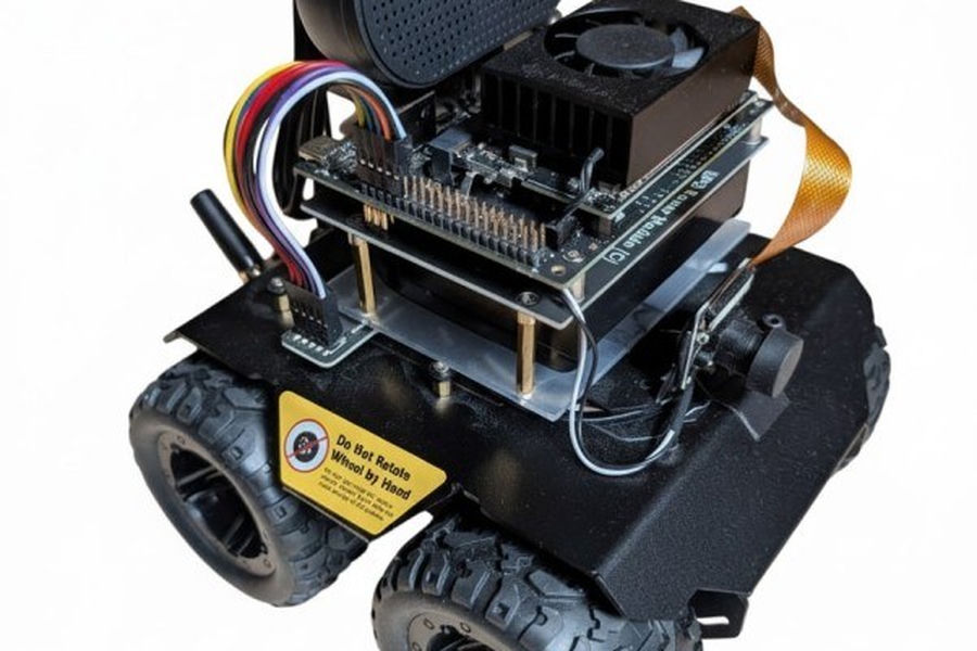 Jetson Orin Nano mounted on a small four-wheel rover chassis with a camera, speaker and cooling fan