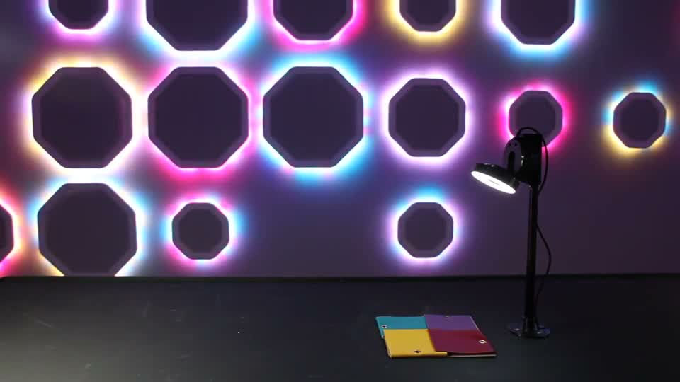 Journey of Colour light sculpture with coloured octagonal outlines, a camera and colour samples in front
